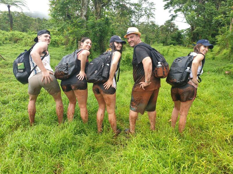 A family showing off their muddy backsides after completing a challenging hike to Lake Lanoto'o Samoa.
