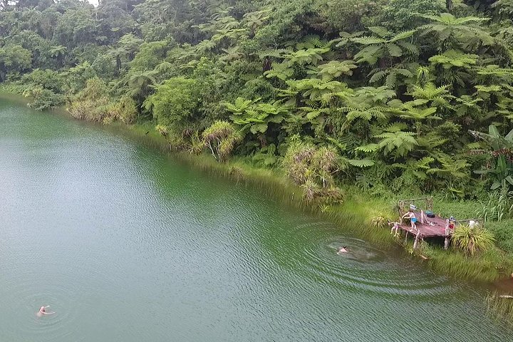 An overhead rone view of people sitting on the deck and swimming in Lake Lanoto'o Samoa.
