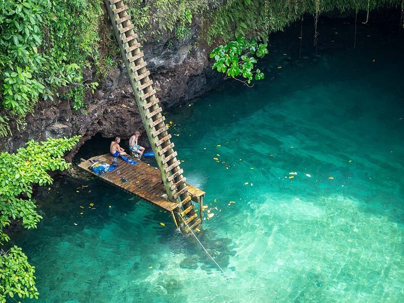 People sitting on the deck at the base of To Sua Ocean Trench.