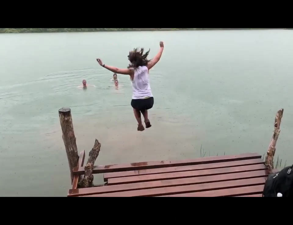 A femal leaping off the deck into the water of Samoa's Lake Lanoto'o.